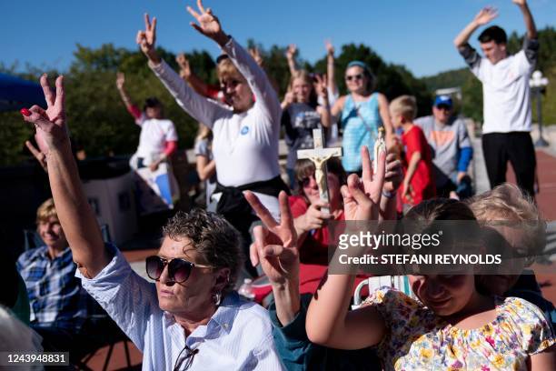 Attendees hold up two fingers during a rally encouraging voters to vote yes on Amendment 2, which would add a permanent abortion ban to Kentuckys...