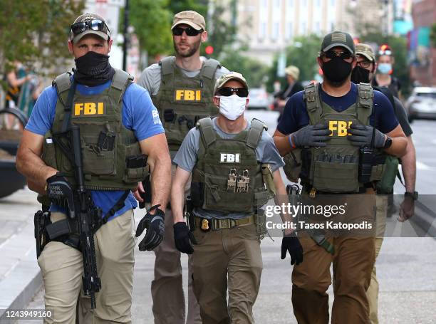 Members of the FBI carry weapons as protests continue against police brutality and the death of George Floyd, on June 3, 2020 in Washington, DC....