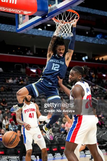 Ja Morant of the Memphis Grizzlies sticks his tongue out after dunking the ball against Isaiah Stewart of the Detroit Pistons during the third...