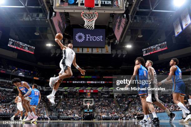 Keldon Johnson of the San Antonio Spurs drives to the basket against the Oklahoma City Thunder during a preseason game on October 13, 2022 at the...