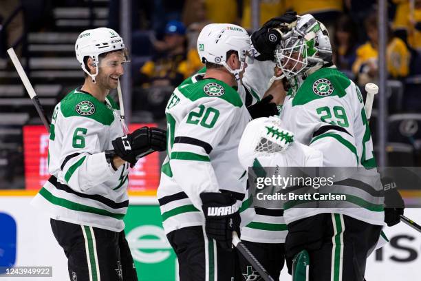 Goaltender Jake Oettinger of the Dallas Stars is congratulated by teammates for his performance against the Nashville Predators after the third...