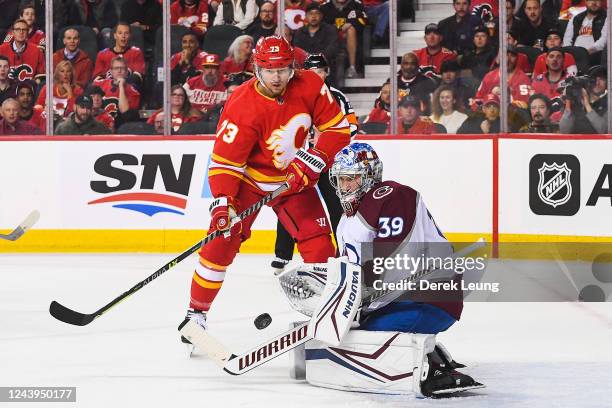 Tyler Toffoli of the Calgary Flames takes a shot on Pavel Francouz of the Colorado Avalanche during an NHL game at Scotiabank Saddledome on October...