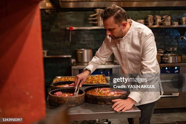 In this photograph taken on October 8, 2022 Turkish chef Fatih Tutak works at his restaurent in Istanbul. - Fatih Tutak was awarded two stars to his...