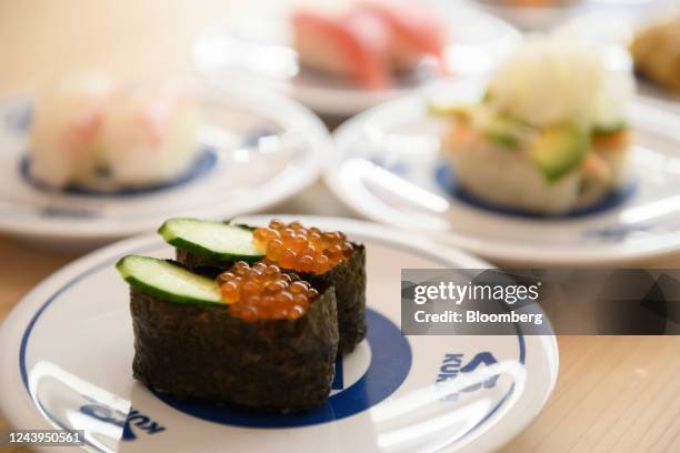 Plates of sushi, including salmon roe, front, at Kura Sushi Inc.'s Harajuku store in Tokyo, Japan, on Wednesday, Sept. 21, 2022. Over the years, some...