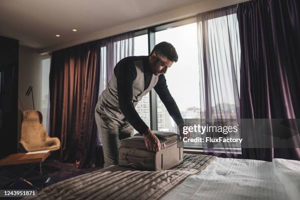 businessman leaving his hotel suite - high society stock pictures, royalty-free photos & images
