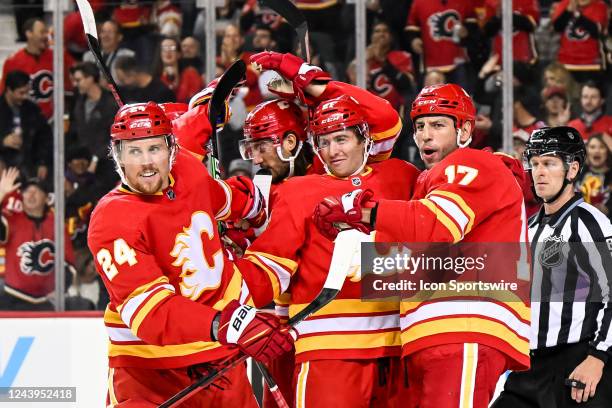 Calgary Flames Right Wing Brett Ritchie celebrates a goal with Calgary Flames Center Kevin Rooney , Calgary Flames Defenceman Christopher Tanev ,...