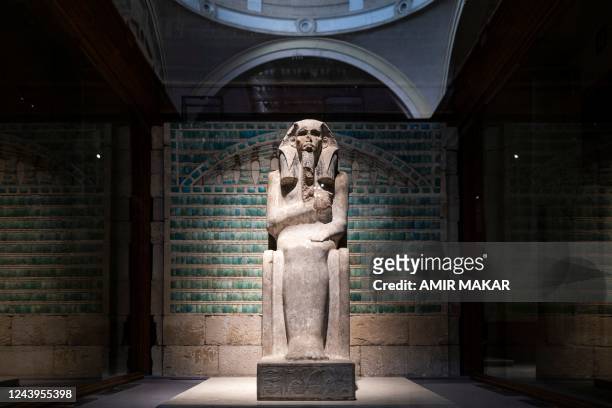 This picture taken on October 11, 2022 shows a view of the painted limestone enthroned Ka statue of the ancient Egyptian third dynasty King...