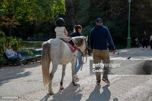Child takes part in a pony ride at Parc Monceau in Paris on October 12, 2022. - On Wednesdays and weekends children can take part in rides between...