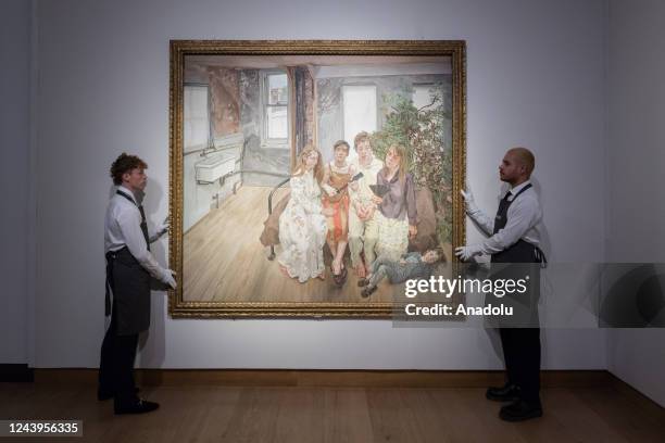 Art handlers hold a painting titled 'Large Interior, W11 ' by Lucian Freud during a photo call to present the highlights from the estate of the...