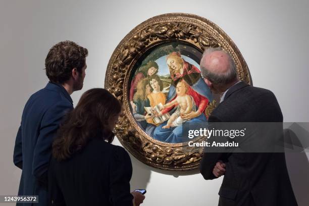 Visitors look at a painting titled 'Madonna of the Magnificat' by Alessandro Filipepi, called Sandro Botticelli during a photo call to present the...