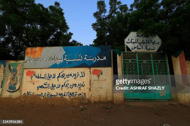 View of the entrance of a school for girls in Burri, in the eastern part of the Sudanese capital Khartoum, on September 14, 2022. - Sudan's children...