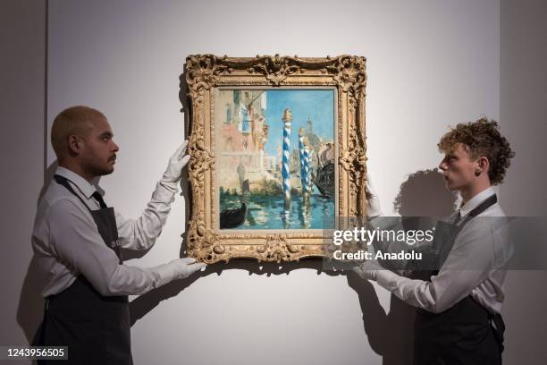 Art handlers hold a painting titled 'Le Grand Canal a Venise' by Edouard Manet during a photo call to present the highlights from the estate of the...