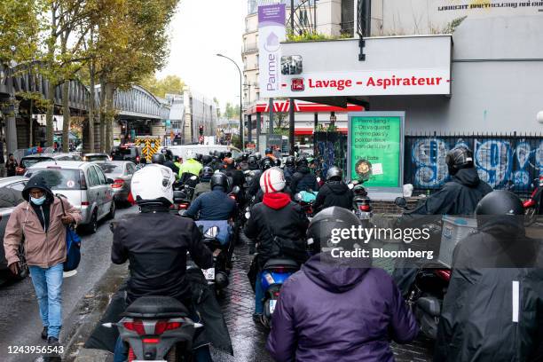 Scooter riders queue for fuel at an Avia International gas station in Paris, France, on Friday, Oct. 14, 2022. Refinery worker walkouts, which have...