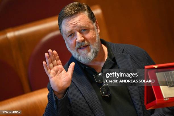 New Zealand actor Russell Crowe waves during a ceremony of career achievement honorary award handed to him by the city of Rome on October 14, 2022 at...