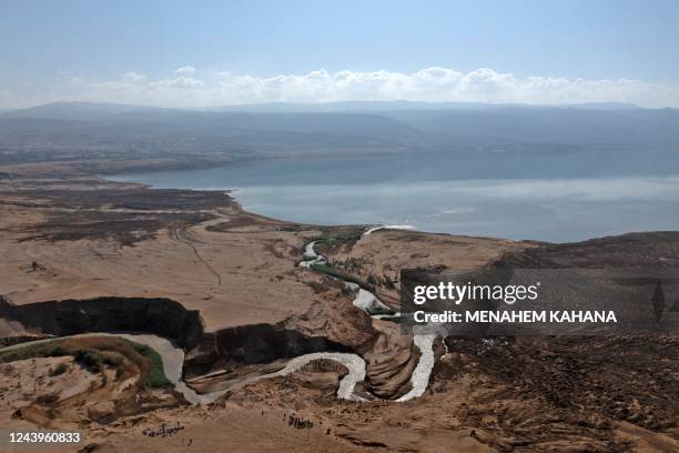 Group of Israeli hikers walk on the hills near the Jordan River where the stream pours into the Dead Sea, near the West Bank city of Jericho, on...