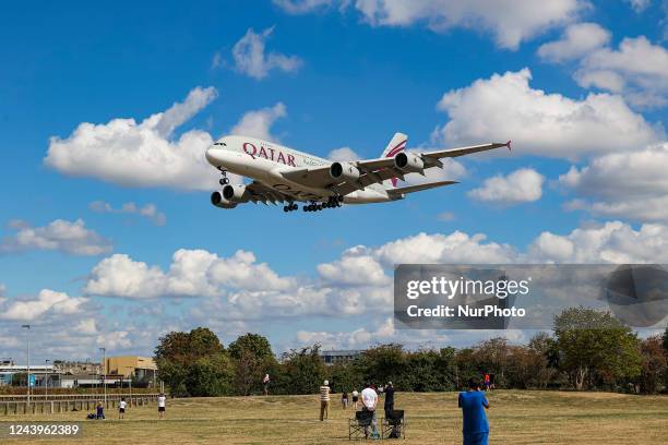 Qatar Airways Airbus A380 aircraft as seen on final approach flying over Myrtle Avenue the famous plane spotting location, for landing at London...