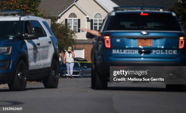 Resident walks along Castle Pines Drive in the Hedingham neighborhood on October 14, 2022 in Raleigh, North Carolina. Police are investigating a...