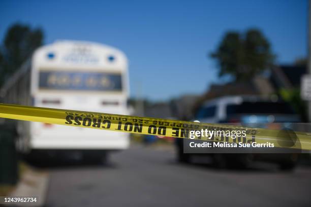 Crime scene tape crosses Castle Pines Drive on October 14, 2022 in Raleigh, North Carolina in the Hedingham neighborhood where 5 people were shot and...