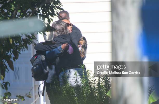 Neighbors hug at the Hedingham neighborhood on October 14, 2022 in Raleigh, North Carolina. Police are investigating a 2-mile area of land around the...