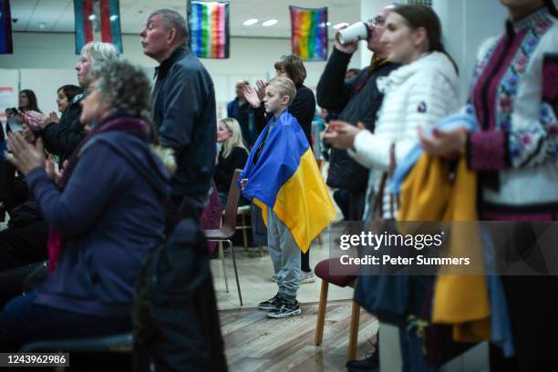 Young boy wears a Ukrainian flag during a performance aboard the MS Victoria ship on October 14, 2022 in Edinburgh, Scotland. Children of Ukrainian...