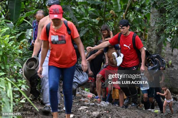 Venezuelan migrants arrive at Canaan Membrillo village, the first border control of the Darien Province in Panama, on October 12, 2022. - The...