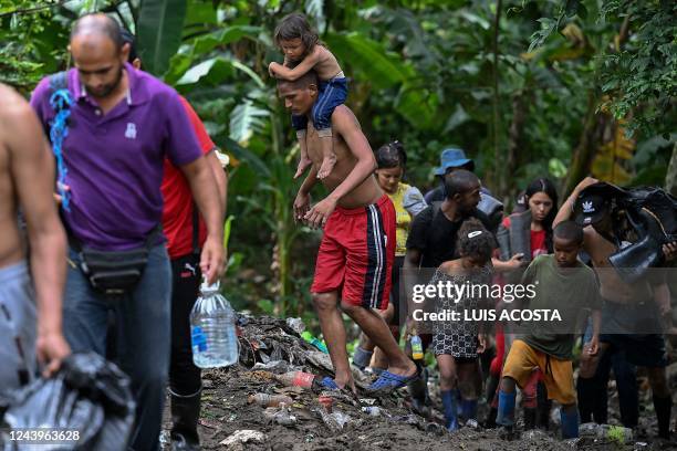 Venezuelan migrants arrive at Canaan Membrillo village, the first border control of the Darien Province in Panama, on October 12, 2022. - The...