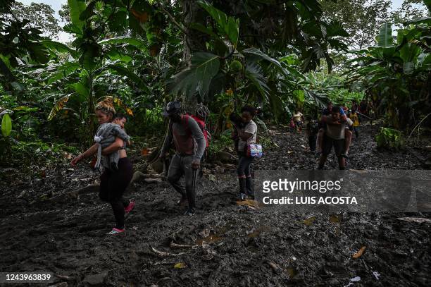 Venezuelan and Haitian migrants arrive to Canaan Membrillo village, the first border control of the Darien Province in Panama, on October 13, 2022. -...