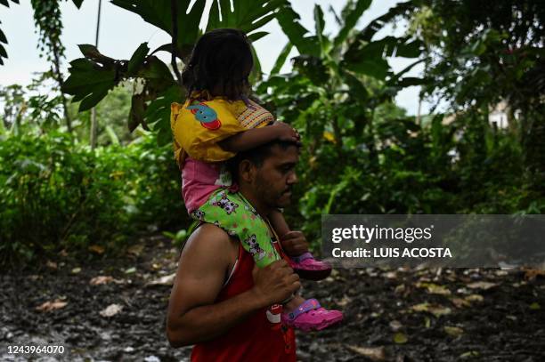 Venezuelan migrants arrive at Canaan Membrillo village, tthe first border control of the Darien Province in Panama, on October 13, 2022. - The...