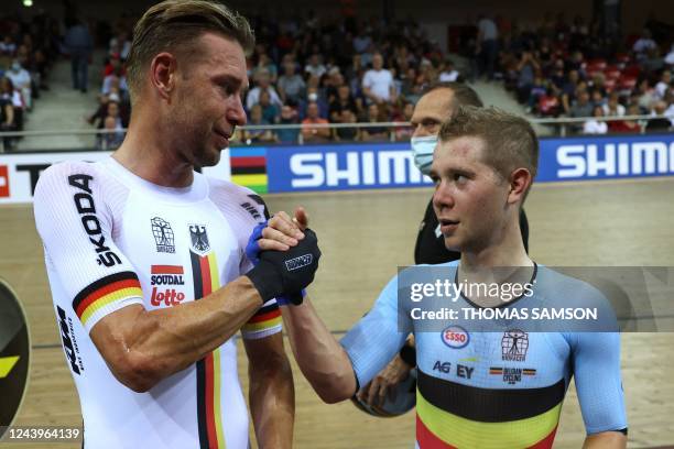 Germany's Roger Kluge celebrates his second place with Belgium's Fabio Van Den Bossche who placed third after the Men's Points Race 40 km final...