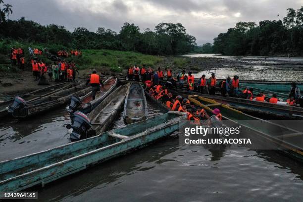 Migrants queue to be transported from Canaan Membrillo village to the Migrants Reception Station in Meteti, Darien Province, Panama, on October 13,...