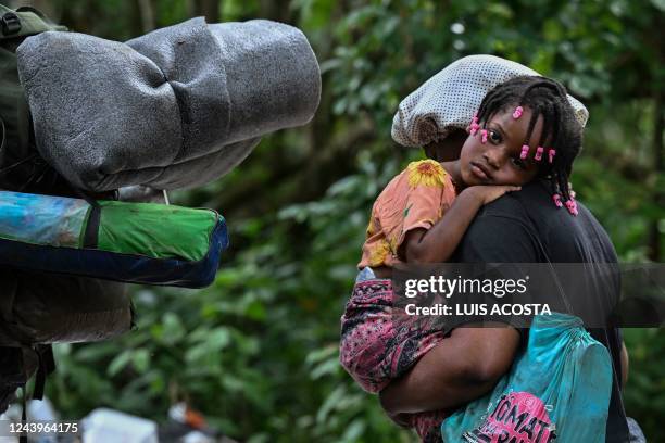 Venezuelan migrants arrive at Canaan Membrillo village, the first border control of the Darien Province in Panama, on October 13, 2022. - The...