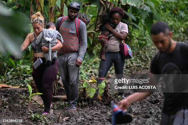 Venezuelan migrants arrive at Canaan Membrillo village, the first border control of the Darien Province in Panama, on October 13, 2022. - The...