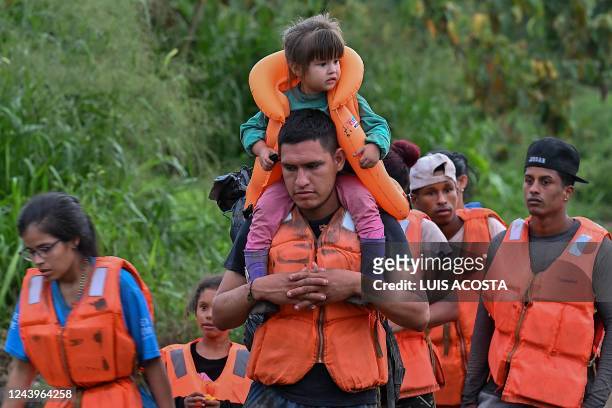 Migrants queue to be transported from Canaan Membrillo village to the Migrants Reception Station in Meteti, Darien Province, Panama, on October 13,...