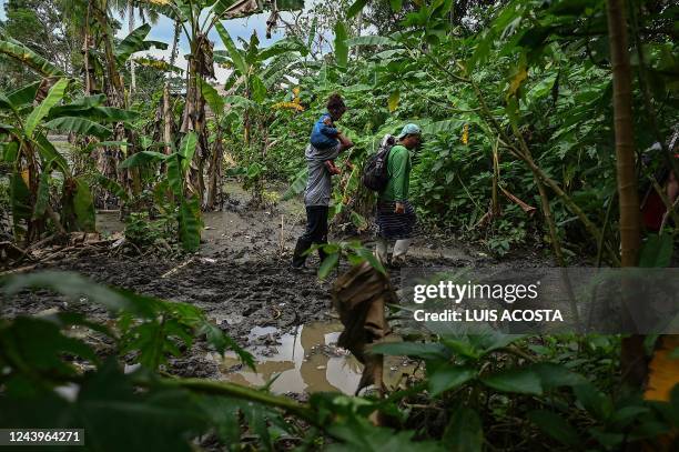 Venezuelan migrants arrive at Canaan Membrillo village, the first border control of the Darien Province in Panama, on October 13, 2022. - The...