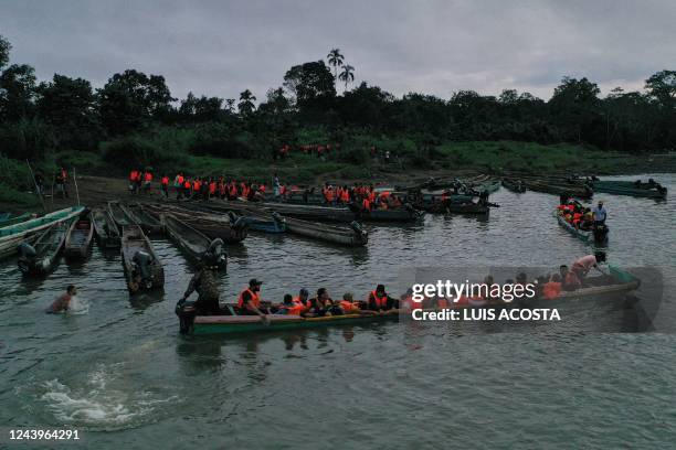 Migrants queue to be transported from Canaan Membrillo village to the Migrants Reception Station in Meteti, Darien Province, Panama, on October 13,...