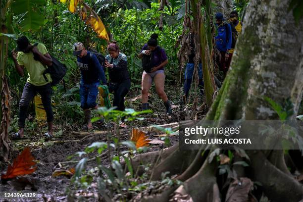 Venezuelan migrants arrive at Canaan Membrillo village, the first border control of the Darien Province in Panama, on October 13, 2022. - The...