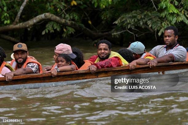 Haitian migrants are seen during their travel in a pirogue to Meteti through the Chucunaque river from Canaan Membrillo village, the first border...