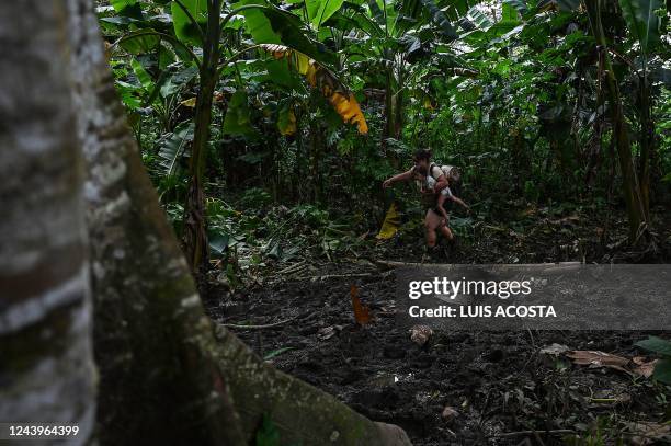 Venezuelan migrants arrive at Canaan Membrillo village, the first border control of the Darien Province in Panama, on October 13, 2022. - The...