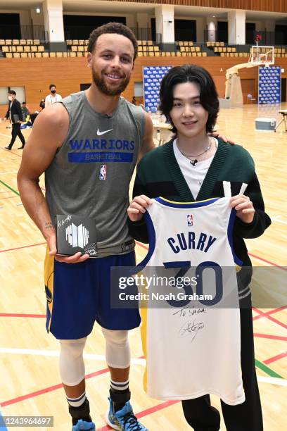 Stephen Curry of the Golden State Warriors poses for a photo with BTS member SUGA after practice and media availability at Minato Sports Complex on...