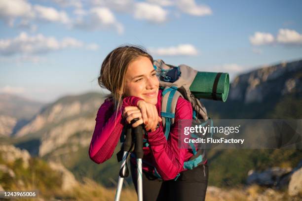 happy female hiker enjoying the mountain sun - hiking pole stock pictures, royalty-free photos & images