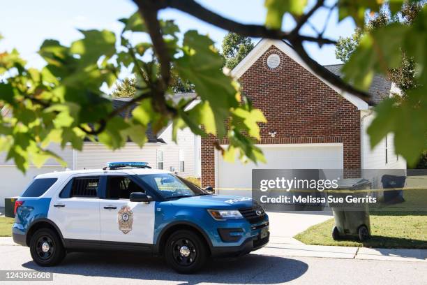Police officer parks in front of the home of the suspect of a shooting in Raleigh that left 5 dead and 2 injured on October 14, 2022 in Raleigh,...
