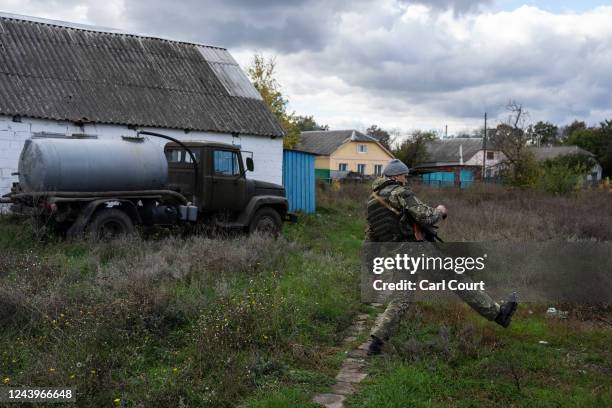 National guard special operations soldier, Alexander Lemyshka, takes a large step to avoid standing on unpaved ground as he checks for booby traps...