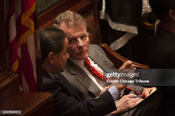 House Speaker Mike Madigan confers with Rep. Edward âEddieâ Acevedo on the bench behind the Speaker's podium in the House chambers at the Illinois...