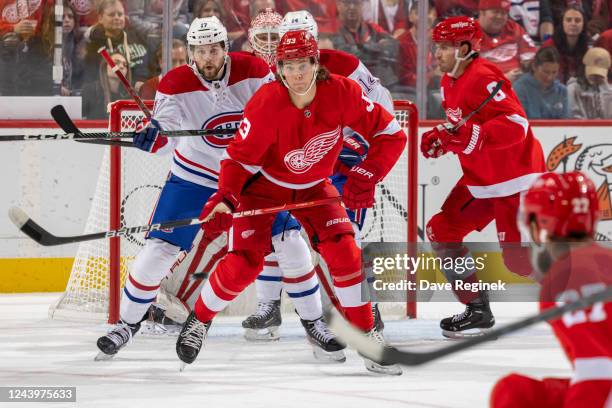 Moritz Seider of the Detroit Red Wings defends in front with Josh Anderson of the Montreal Canadiens during the first period an NHL game at Little...