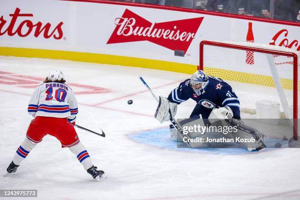 Artemi Panarin of the New York Rangers takes a shot on goaltender Connor Hellebuyck of the Winnipeg Jets during a first period breakaway at the...