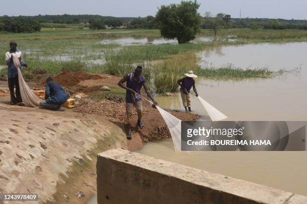 Inhabitants of the village of Kwatcha fish in the Niger river near Gaya, at the Niger border with Benin, on October 9, 2022.