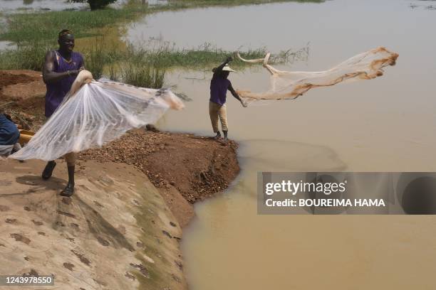 Inhabitants of the village of Kwatcha fish in the Niger river near Gaya, at the Niger border with Benin, on October 9, 2022.