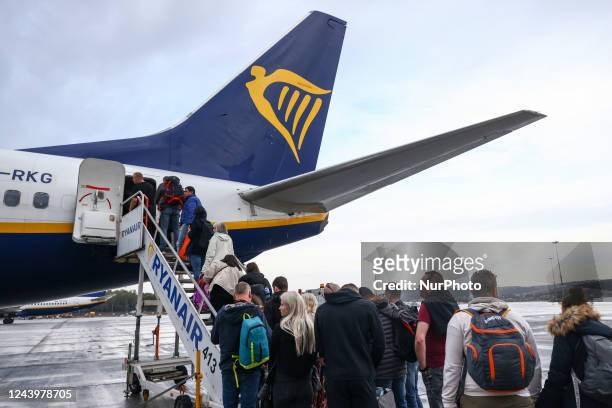 Passengers are boarding Ryanair airplane at Krakow Airport in Balice near Krakow, Poland on October 11, 2022.