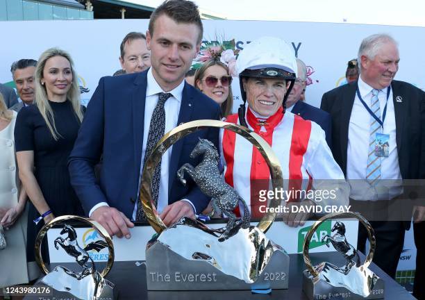 Trainer Clayton Douglas and jockey Craig Williams of Giga Kick pose with the Everest 2022 horse race trophy at the Royal Randwick race course in...