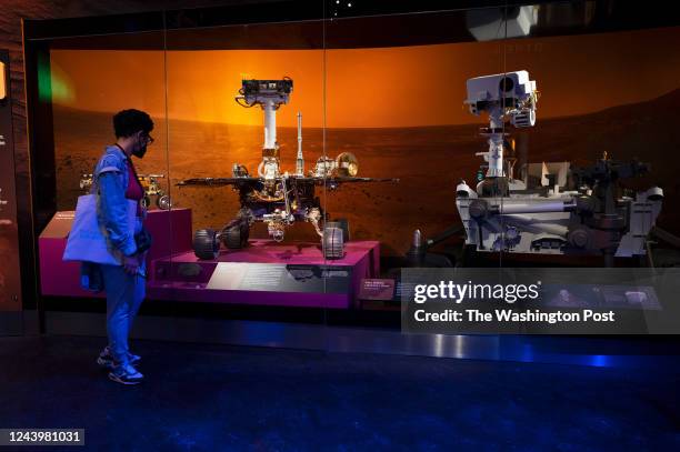 Person looks at models of Mars rovers in the Smithsonians National Air and Space Museum in Washington, DC on October 06, 2022.